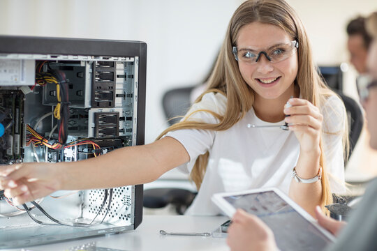 Students assembling computer in class
