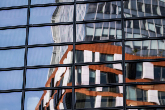 Abstract urban pattern of modern building glass facade with windows and reflection creating architectural texture background for corporate design