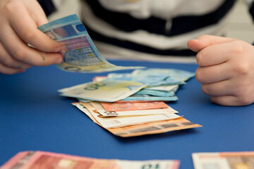 I count money for rent. The concept of saving money. Finance, business, investment. Saving savings at home. Spending cash on losses, real estate, debts, taxes. Inflation, poverty, economic crises.