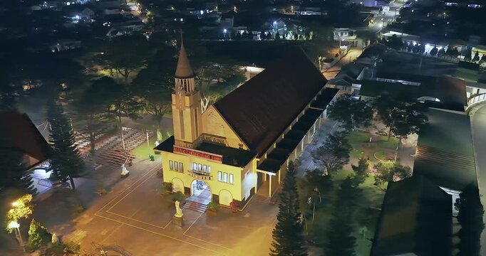 Aerial view of Tan Ha parish church Bao Loc, Vietnam at night, a place for parishioners to come to confession and pray for peace for their families
