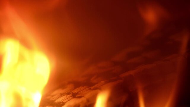 Very close-up shot of flames coming out of a burning log