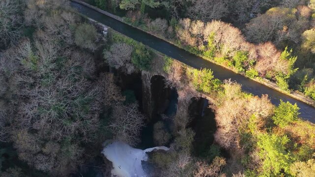 Aerial View Of Ponte Peon - Historic Stone Aqueduct Above San Crimenzo River In Dumbria, Spain. rotating shot