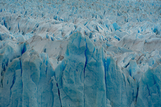 View of the jagged, icy expanse of Perito Moreno Glacier, a frozen river of blue and white, stretching towards the horizon, El Calafate, Santa Cruz Province, Argentina.