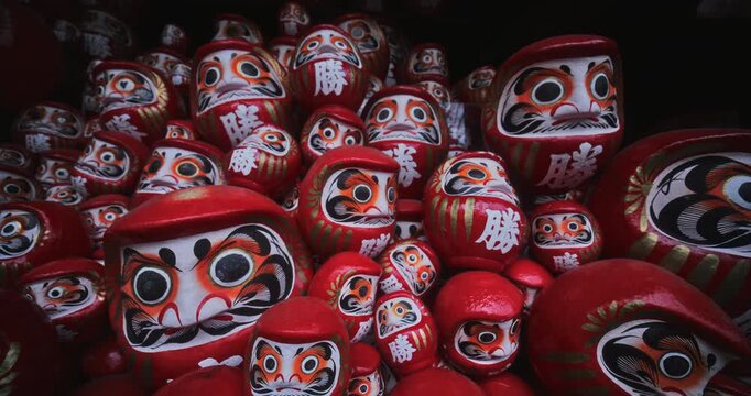 Steady cam movement across endless amount of daruma dolls in wooden structure