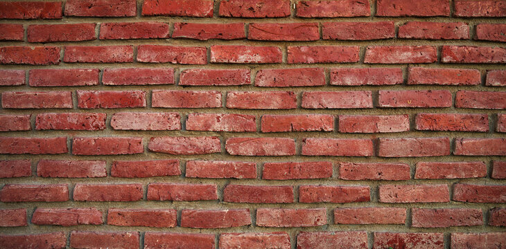 High resolution red brick panoramic wall view. Weathered brick wall building surface