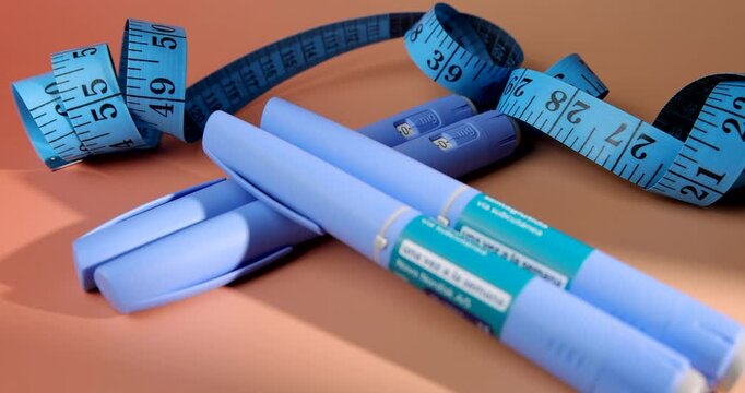 Panning shot of blue semaglutide GLP-1 pens and a measuring tape for medical weight loss and type 2 diabetes management clinical ads.