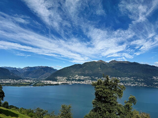 Fototapeta premium Lake Maggiore with its coastal town, ships, houses and mountains in late summer