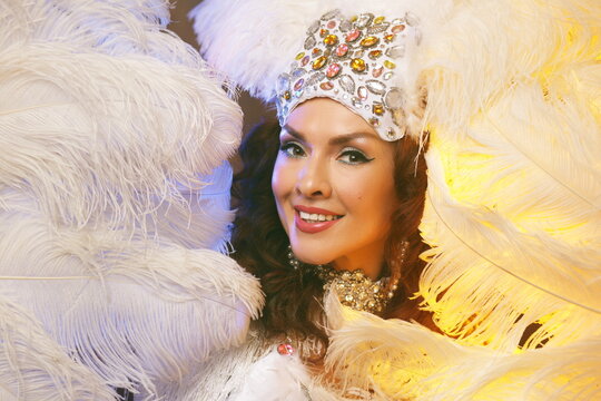 Radiant Showgirl Portrait in White Feathers and Gold Light