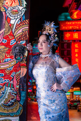 Chinese new year 2026 celebration with woman in traditional dress standing by colorful door in vibrant night street Celebrating lunar new year