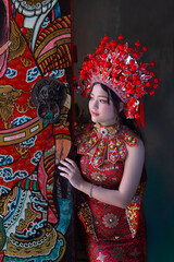 Chinese new year 2026 concept, Young woman red traditional dress and elaborate headdress celebrates Chinese New Year 2026 with vibrant colors. Celebrating lunar new year