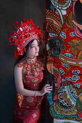 Young woman traditional red dress and elaborate headdress celebrates Chinese New Year 2026 with vibrant colors Celebrating lunar new year