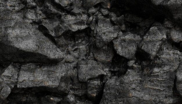 Close-up, rough, dark charcoal-like rock surface featuring jagged, angular textures and deep shadows, highlighting its natural, uneven structure