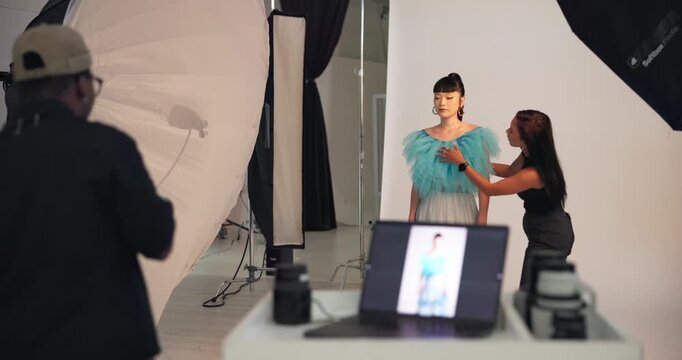 Stylist, woman and model with photographer for fashion photoshoot, production process or picture. Photography, bts and capture image with people, styling or outfit preparation in creative studio