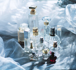 Dreamy luxury flat lay of assorted elegant perfume bottles in crystal, glass, and jewel tones, romantic feminine atmosphere perfect for beauty, fragrance, and high-end lifestyle concepts.