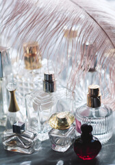 Dreamy luxury flat lay of assorted elegant perfume bottles in crystal, glass, and jewel tones, romantic feminine atmosphere perfect for beauty, fragrance, and high-end lifestyle concepts.