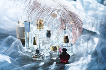Dreamy luxury flat lay of assorted elegant perfume bottles in crystal, glass, and jewel tones, romantic feminine atmosphere perfect for beauty, fragrance, and high-end lifestyle concepts.