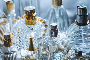 Dreamy luxury flat lay of assorted elegant perfume bottles in crystal, glass, and jewel tones, romantic feminine atmosphere perfect for beauty, fragrance, and high-end lifestyle concepts.