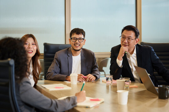 Group of male and female entrepreneurs discussing strategies in office meeting