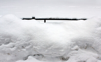 Snow-covered fence with only top edge visible &mdash; ideal for urban boundary documentation, winter hazard awareness and minimalist design background
