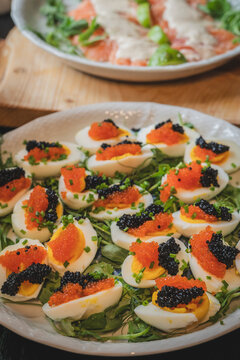Deviled eggs with two types of caviar served on plate