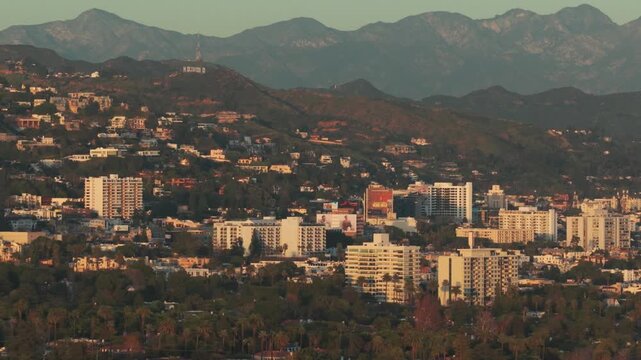 Aerial telephoto dolly shot of West Hollywood at sunset in Southern California. 4K