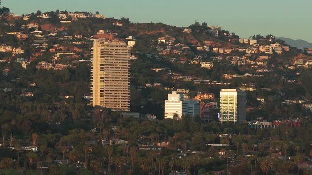 Telephoto panning aerial shot of Sunset Plaza in West Hollywood at golden hour in Los Angeles, California. 4K