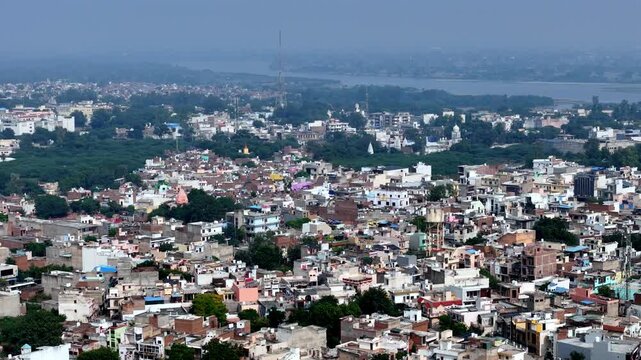 Aerial video of colorful rooftops of Mathura unfold beside the Yamuna river, where temples, homes, and sacred ghats weave together in the spiritual heartland of Krishna&rsquo;s birthplace.