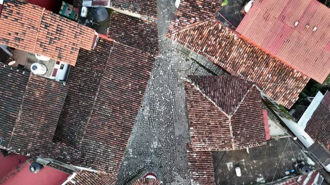 Cuetzalan town cobbled street and stone houses with terracotta roofs, Drone