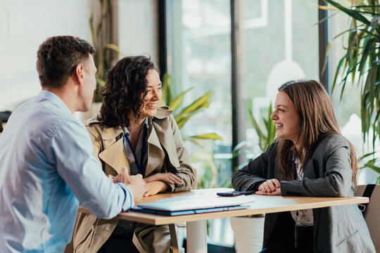 Coworkers enjoying coffee break and relaxed conversation