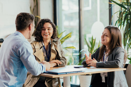 Coworkers collaborating and smiling during a business meeting
