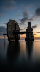 Coastal structures silhouetted against evening sky