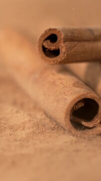 Slow Motion, Cinnamon Curl Under Soft Glow. Detailed Shot Capturing Cinnamon Spiral And Fragrant Particles