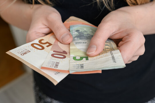Paper euro banknotes held in the hands of a girl