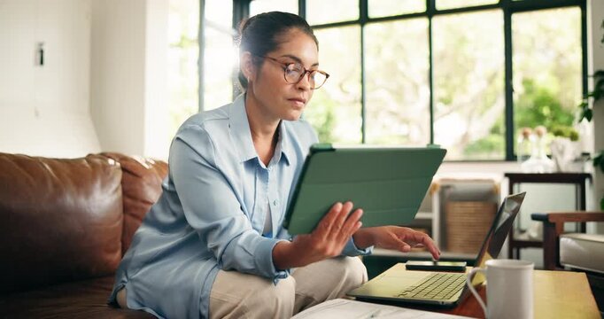 Home, laptop and woman with tablet, typing and multitasking for story research, online or journalism. Reading, article and person with glasses for fact checking, reporter and creative for remote work