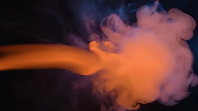 Adobepremiumvideo orange liquid splash with smoke effect on dark background adobepremiumvideo footage