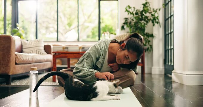 Yoga, woman and playing with cat in home for fitness break, connection and furry companion. Kitty owner, happy yogi and stroke pet on mat for post exercise, bonding together and loyalty in apartment