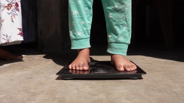 Barefoot Person Weighing on Digital Scale
