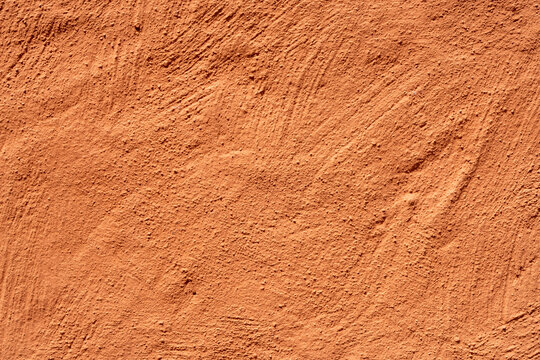 Rough orange terracotta stucco wall texture background