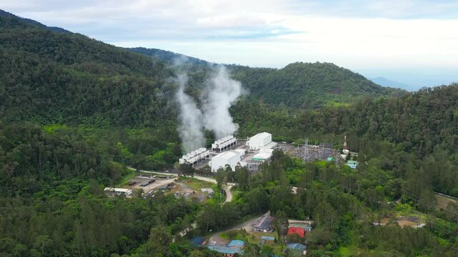 Aerial drone of Geotermal power plant on Mount Apo. Geothermal station with steam and pipes in the rainforest. Mindanao, Philippines.
