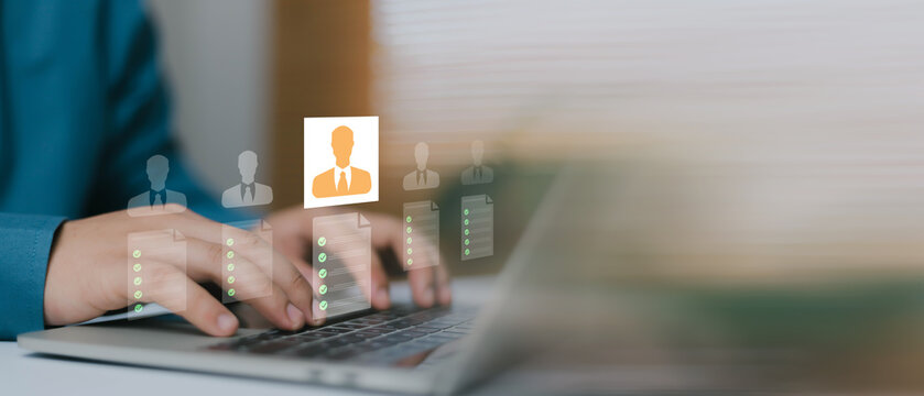 Business professional reviewing job candidates on laptop with digital resume screening interface, recruitment process, talent selection, human resources management and hiring strategy concept.