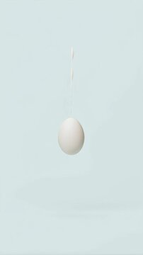 Minimal single white Easter egg floating on soft pastel background. Clean modern spring composition with elegant simplicity and copy space