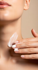 Naklejka premium Woman applies cream to neck with fingers.