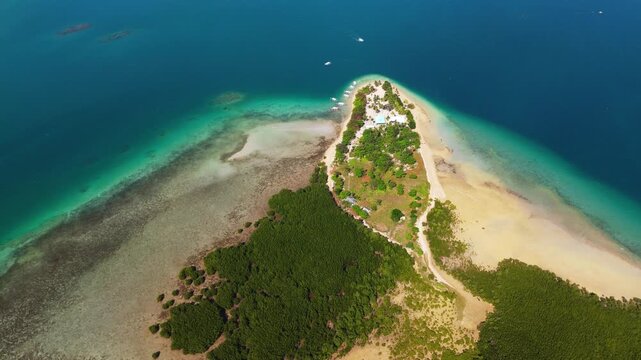 aerial top down view of Cowrie Island, surrounded by the crystal-clear turquoise waters of Honda Bay in Puerto Princesa, Palawan Philippines
