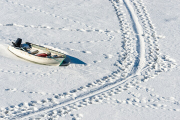 Boats moored in the snow at Ilulissat harbour in Greenland during winter season