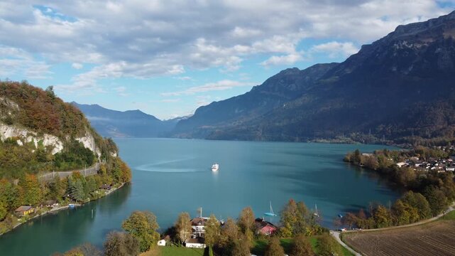 A smooth frontal traveling shot moves through the heart of Interlaken, nestled between two turquoise lakes in the Bernese Oberland. The Eiger, M&ouml;nch, and Jungfrau peaks in the background.