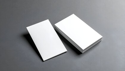 Clean, white stack of blank business cards on gray surface, angled view