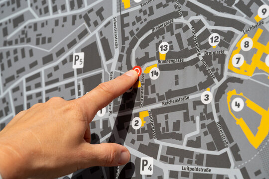 Hand pointing on city street map navigating in F&uuml;ssen