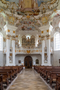 Wieskirche interior showcasing rococo architecture, fresco ceiling, and organ in Steingaden
