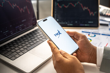 Fototapeta premium TMX Group logo is displayed on the screen of a smartphone, in Bangalore, India, on February 12, 2026