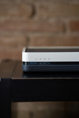 Modern internet modem displaying bright blue indicator lights, signifying active connectivity and a strong wireless signal for home networking and data transmission